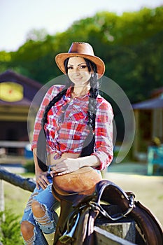 Western,cowboy,cowgirl,rodeo.Cowgirl in western style on the far