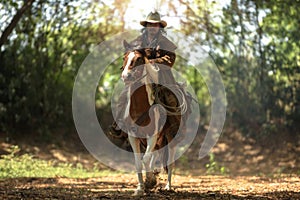 Western cowboys riding horses are running at speed.