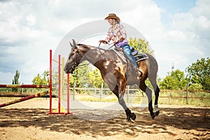 Western cowgirl woman training riding horse. Sport