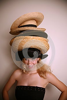 Western girl wearing many hats