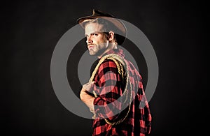 Western life. Man wearing hat hold rope. Lasso tool of American cowboy. Lasso is used in rodeos as part of competitive