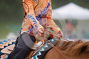 Western Rider in Sparkly, Orange Blouse