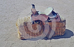 Western Round Skirt Saddle On Hay Bale