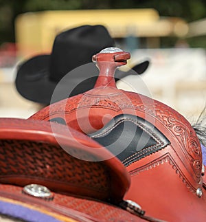 Western saddle with cowboy hat and leather harness