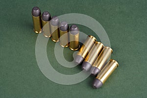 Western-style revolver cartridges on green