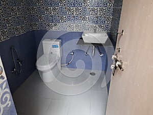 Western toilet pot, washbasin, floor tiles, dado, tapes, toilet interior photo