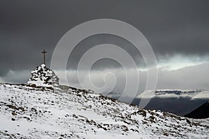 Westfjords of Iceland summit cross covered in snow
