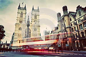 Westminster Abbey church, red bus moving in London UK. Vintage