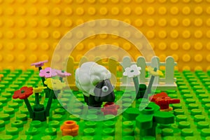 Weston-super-Mare UK. February 2020.lego toys sheep on field with flowers. Lego minifigures are manufactured by The Lego Group.