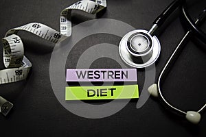 Westren Diet text on Sticky Notes. Top view isolated on black background. Healthcare/Medical concept