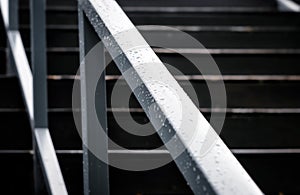 Wet Aluminum Staircase Handrail on a Cold Raining Day