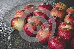 Wet apples on a granite rock in the rain