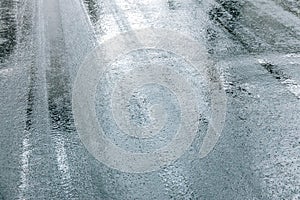 Wet asphalt road surface with sky reflect