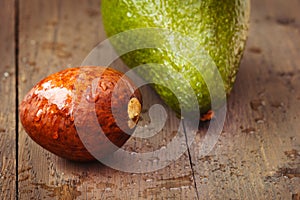 Wet avocado core on brown wooden old table