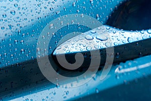 Wet blue car door handle detail water drops