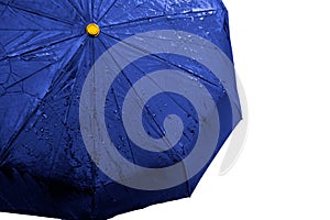 Wet blue umbrella close up image on isolated background. Waterproof fabric cloth with water drops and splashes. Good or bad