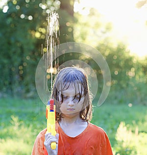 Wet Boy Fooling Around Squirting Water photo