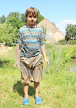 Wet boy by pond