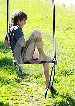 Wet boy on a swing