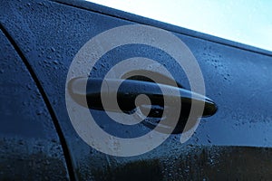 Wet car with door handle outdoors, closeup view