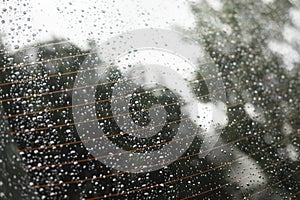 Wet car glass. Raindrops on glass of car. Wet surface