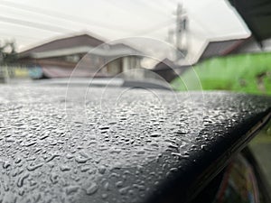 Wet car roof after heavy rain