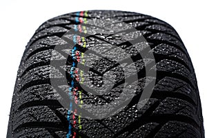 Wet car tire on white