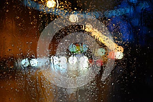 Wet the car window with the background of the night city