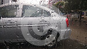 Wet car window windshield glass during heavy monsoon rains in India