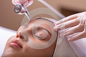 Wet cleaning of the face with a special device. Cleaning, softening and moisturizing the female face