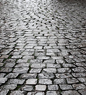 Wet cobbles of block pavement