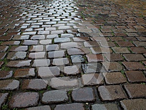 Wet cobblestone pavement