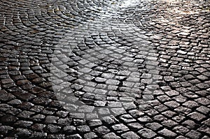 Wet cobblestone pavement after rain