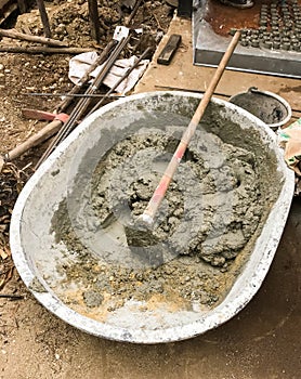 Wet concrete in bucket with shovel