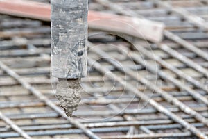 Wet concrete dripping from a large hose