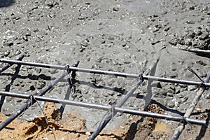 Wet concrete is poured into wire mesh