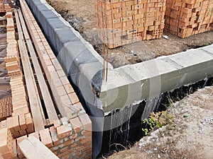 Wet concrete is poured on wire mesh steel reinforcement