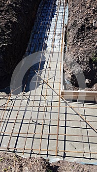 Wet concrete is poured on wire mesh steel reinforcement