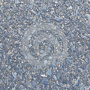 Wet concrete road with crushed stone macro shot. Textural background.