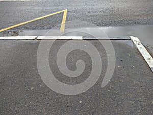 wet curbs enclosing the bus stop after rain top view