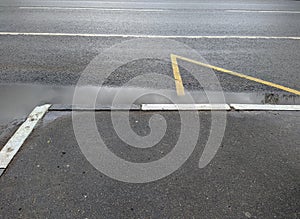 wet curbs enclosing the bus stop after rain top view