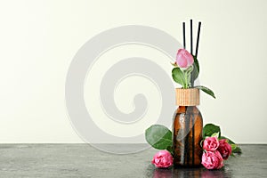 Wet diffuser bottle with sticks and pink roses