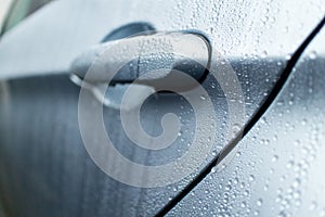 Wet door handle of a luxury sedan