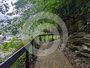 Wet and empty Shakadang Trail crawls along cliffs and trees with Liwu River in a mist during the pandemic before 403