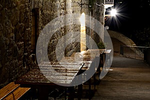 Wet, empty, wooden restaurant tables at night