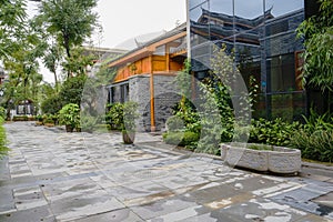 Wet flagstone pavement before Chinese traditional buildings after rain
