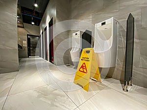 Wet floor alert sign in men toilet