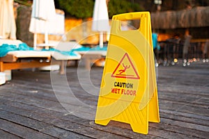 Wet floor caution sign on hotel terrace