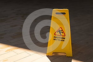 Wet floor caution sign on walkway.