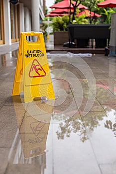 Wet floor warning sign on the floor in hotel corridor